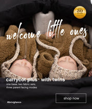Two babies resting in their twin carrycot plus™ while travelling in a Mountain Buggy double pushchair