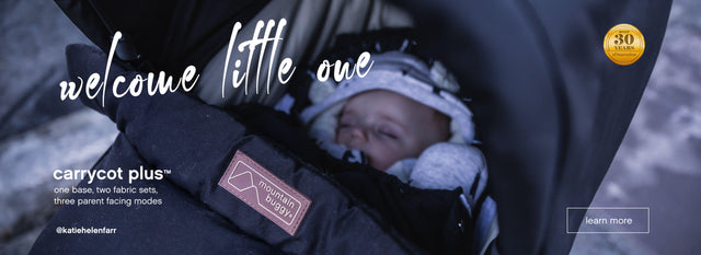 Close-up of baby wrapped up warm while snoozing in carrycot plus™ from Mountain Buggy