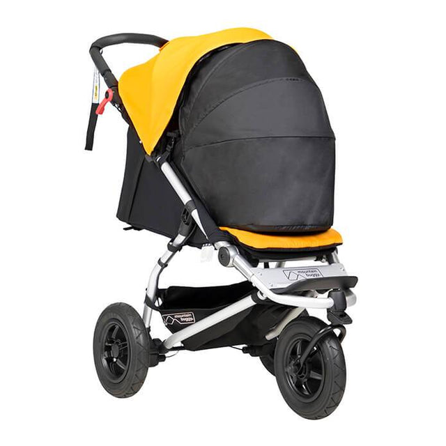 mountain buggy swift compact buggy with newborn cocoon 3/4 view shown in color gold_gold