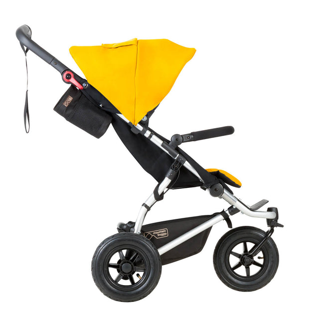 mountain buggy swift  vista lateral del buggy compacto para niños pequeños mostrado en color oro_dorado