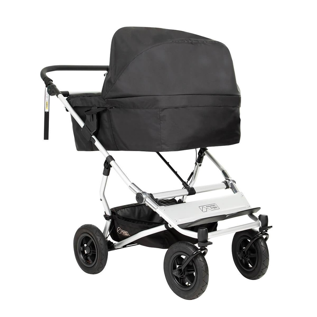 carrycot plus for twins installed on a Mountain Buggy duet double stroller shown from front side angle with sun hood up in place_black_black